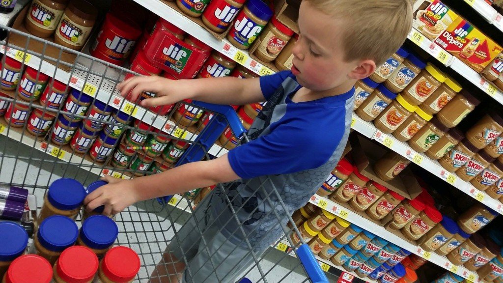 Kids filling a cart with food to donate